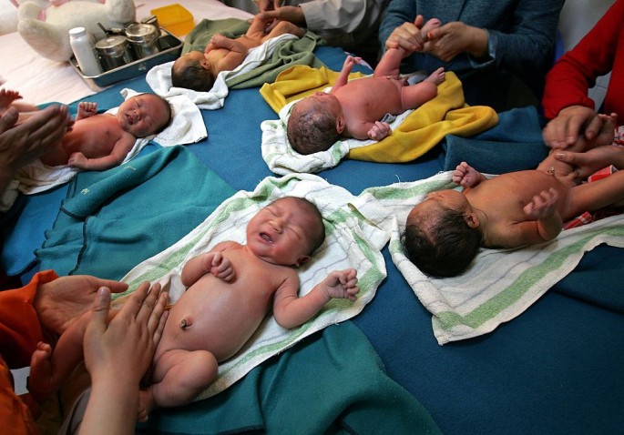 Nurses and parents massage newborn babies at Xining Children Hospital on May 17, 2006, in Xining of Qinghai Province, China.