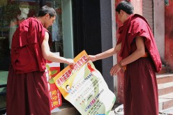 Monks Hold A Poster Promoting The Prevention Of AIDS