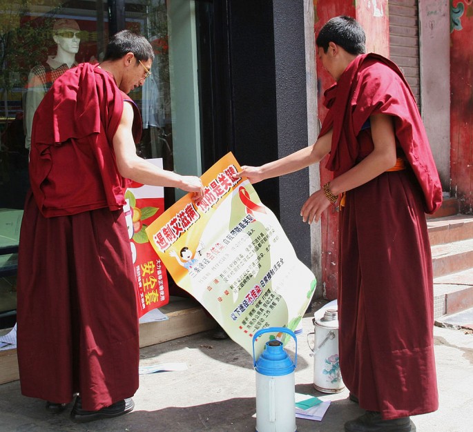 Monks Hold A Poster Promoting The Prevention Of AIDS