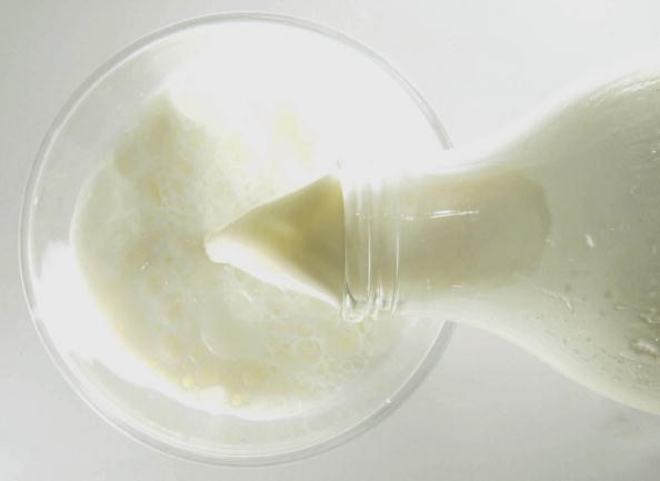 Milk being poured to a glass.