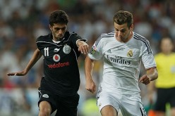 Qatar and Al-Sadd striker Hassan Al-Haidos (L) competes for the ball against Real Madrid's Nacho Fernandez.