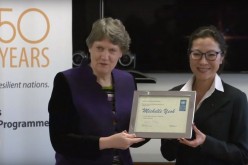 UNDP Administrator Helen Clark gives to a smiling Michelle Yeoh a framed certificate as part of her recent appointment as UNDP Goodwill Ambassador.