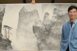 Behind every great artist is a great piece of art, in the literal sense of the word, as shown in the picture: Li Huayi posing with one of his creations.
