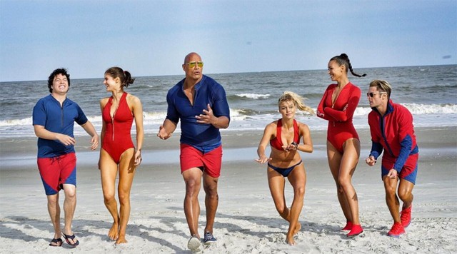 "Baywatch" cast photo shows Dwayne "The Rock" Johnson as a lifeguard along with his team.