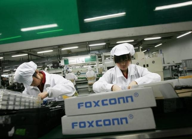 Employees work inside a Foxconn factory in Guangdong Province.