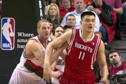 NBA Playoffs 2009 First Round: Yao Ming waits to receive the ball. Close behind to thwart him is the 7-foot-1 Joel Przybilla playing for Portland Trail Blazers.