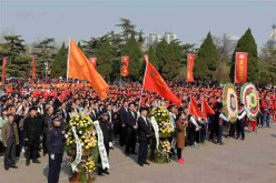 People attend a commemoration ceremony at a martyr cemetery in Jinan, capital of east China's Shandong Province, April 1, 2016. 