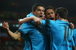 Barcelona's Luis Suárez, Neymar, and Lionel Messi celebrate during their Champions League match against Arsenal.