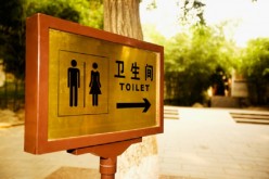A sign indicates where the restroom is in Beihai Park, Beijing. A survey conducted in 2015 revealed that Beijing has good public restrooms.