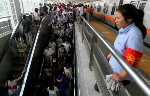 A subway staff member keeps watch at the Zhichunlu Station on the Subway Line 10 in Beijing, China, July 21, 2008.
