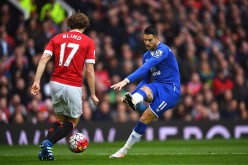 Everton forward Kevin Mirallas shoots past Manchester United defender Daley Blind.