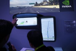 A show attendee checks out the Nvidia DRIVE CX autonomous driving system at CES 2016 at the Las Vegas Convention Center