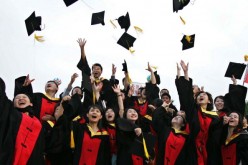 Graduates throw their caps during the graduation ceremony at Shanghai Jiaotong University in Shanghai, China, on June 20, 2005.