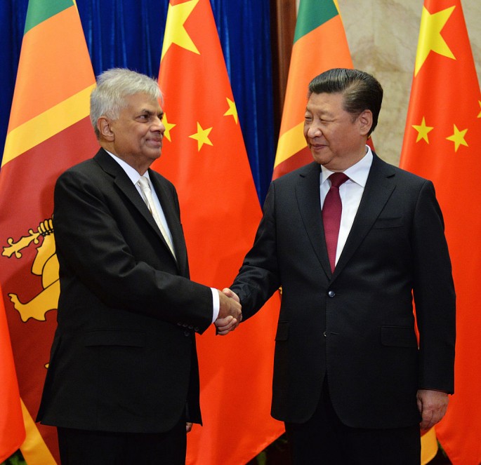 Sri Lankan Prime Minister Ranil Wickremesinghe shakes hands with Chinese President Xi Jinping.