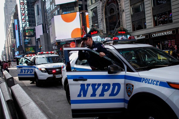 A New York City police exits from a car in Times Square on November 26, 2015 in New York City.   