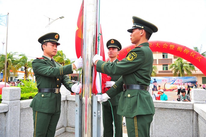 Soldiers raise the Chinese national flag in Sansha City in Xisha Islands.