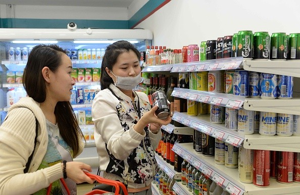 People shop at Xuzhen Supermarket on April 13, 2016 in Shanghai, China. All goods in the supermarket are empty, but the price is the same as usual. 