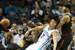 Tim Hardaway Jr. and Mike Scott of the Atlanta Hawks collide with Jeremy Lin of the Charlotte Hornets. 