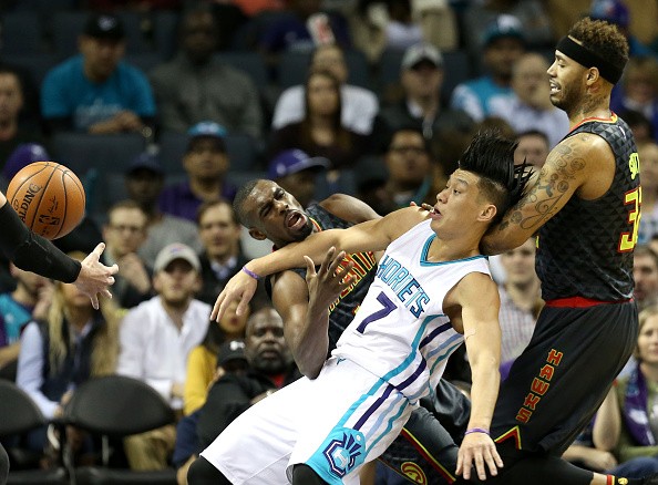 Tim Hardaway Jr. and Mike Scott of the Atlanta Hawks collide with Jeremy Lin of the Charlotte Hornets. 