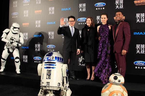J.J. Abrams poses for a photo with Lucasfilm president Kathleen Kennedy and "Star Wars: The Force Awakens" casts Daisy Ridley and John Boyega.