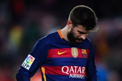Gerard Pique of FC Barcelona leaves the pitch dejected. 