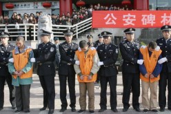 Chinese police parade a group of 15 convicted criminals to be sentenced in public, most of which are likely to face the death penalty, on November 15, 2004 in Xian, China.