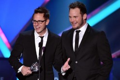 James Gunn accepts an award on stage with 