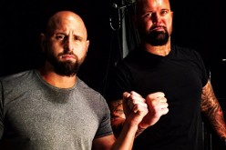 Karl Anderson and Doc Gallows posing backstage.