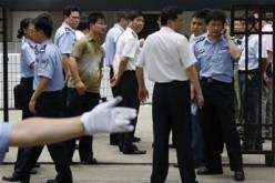 Policemen keep watch outside Shanghai Zhabei's district police station.