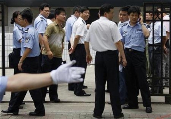 Policemen keep watch outside Shanghai Zhabei's district police station.