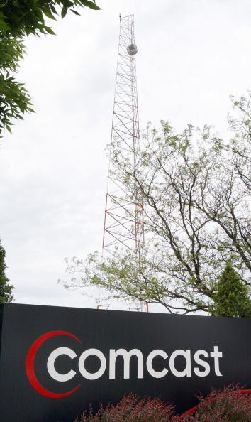 A Comcast sign is seen outside its customer care center June 9, 2004 in Romeoville, Illinois. 
