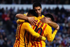 Barcelona striker Luis Suárez (middle) celebrates one of his four goals with teammates Neymar and Lionel Messi.