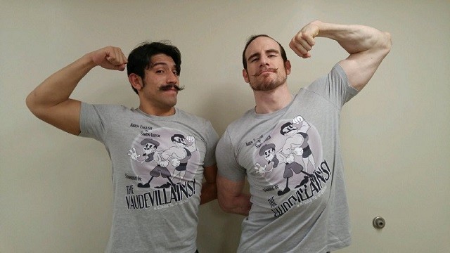 Simon Gotch and Aiden English posing with their new The Vaudevillains merchandise. 
