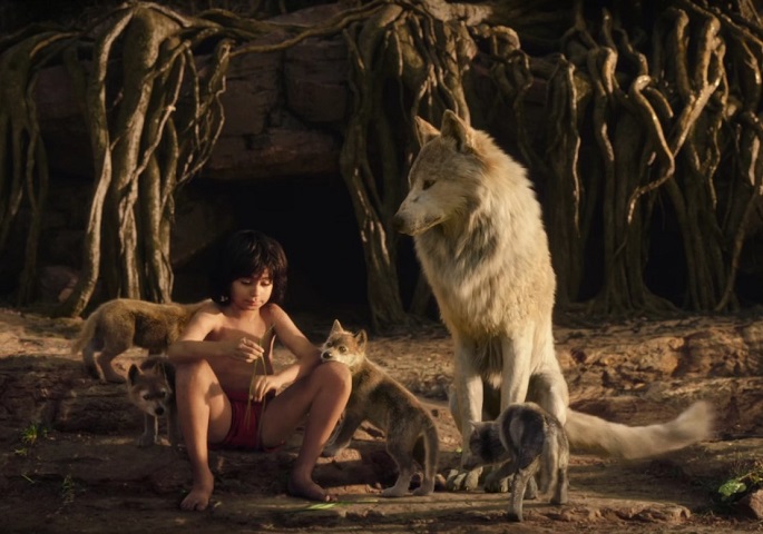 We are family: “Man-cub” Mowgli (Neel Sethi) sits together with his “siblings” and wolf "mother," Raksha (voiced by Academy Award-winning Kenyan-Mexican actress Lupita Nyong’o).
