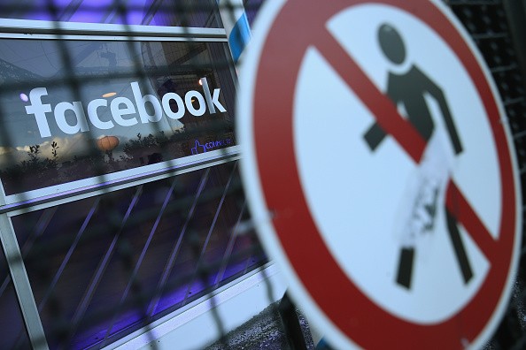 A no entry symbol hangs on an opened gate next to the Facebook logo at the Facebook Innovation Hub on February 24, 2016 in Berlin, Germany.   