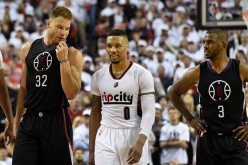 Blake Griffin has some words with Damian Lillard as Chris Paul looks on.