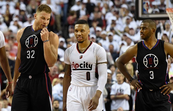 Blake Griffin has some words with Damian Lillard as Chris Paul looks on.