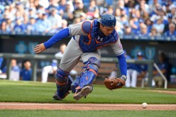 Travis d'Arnaud of the New York Mets chases down a foul ball.