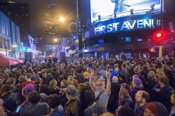 People listen to Prince music during a memorial street party outside the First Avenue nightclub on April 21, 2016 in Minneapolis, Minnesota.     