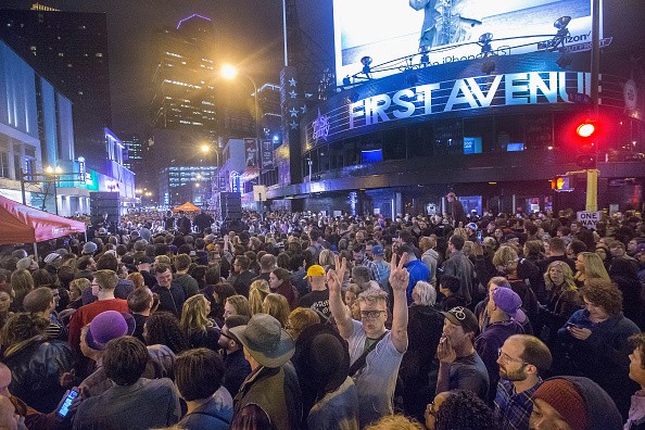 People listen to Prince music during a memorial street party outside the First Avenue nightclub on April 21, 2016 in Minneapolis, Minnesota.     