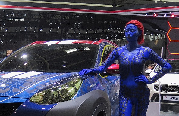 A model stands by a KIA vehicle at the Beijing International Automotive Exhibition on April 25, 2016 in Beijing, China. 