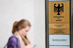 A pedestrian was seen walking while texting near the federal health ministry in Berlin, Germany.