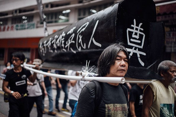 Pro-democracy activists carry a coffin to memorialize the victims of the Tiananmen Square Massacre during a rally on May 31, 2015 in Hong Kong. 