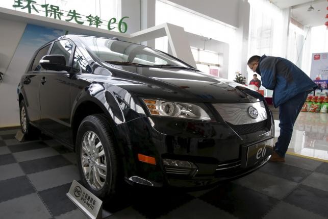 A customer looks at an e6 in an EV car show in Beijing in Dec. 2015.
