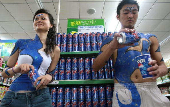 Body Painted Sales People Promote Beverage At Supermarket