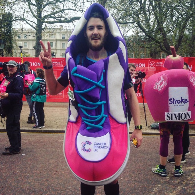 Running for a noble cause: A participant in an attention-grabbing costume makes a peace sign as he poses for the camera during the 2016 London Marathon.