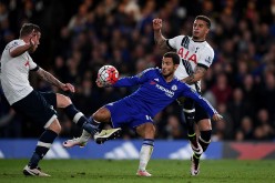 Chelsea winger Eden Hazard (middle) competes for the ball against two Tottenham Hotspur defenders.