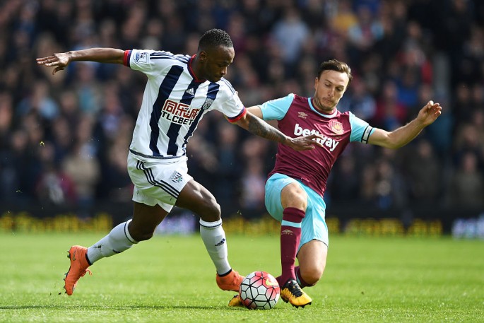 West Ham United captain Mark Noble (R) competes for the ball against West Brom's Saido Berahino.