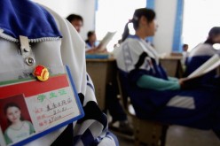 An Uyghur ethnic minority student wears a badge of the Chinese Communist Youth League at a middle school on Oct. 13, 2006 in Hotan City, Xinjiang Uyghur Autonomous Region, China.