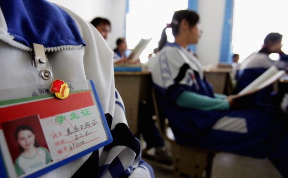 An Uyghur ethnic minority student wears a badge of the Chinese Communist Youth League at a middle school on Oct. 13, 2006 in Hotan City, Xinjiang Uyghur Autonomous Region, China.